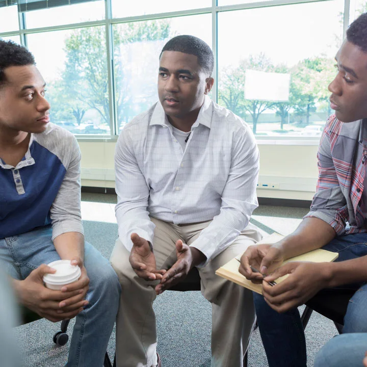 group of men talk in a support group