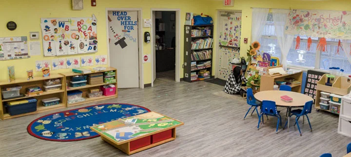 GCCFN therapeutic preschool room with yellow walls and colorful preschool furniture and decor